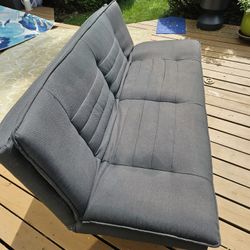 Futon Reclines Into A Bed, Good Condition Black In Color 6ft