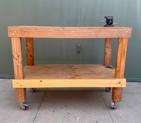 Workbench on wheels with vise.