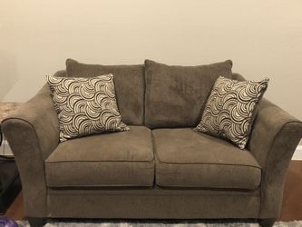 Brown couch and loveseat