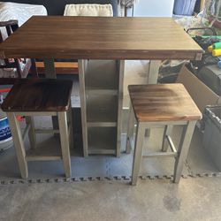 Table With Four Stools And Three Cubby Holes On Each Side