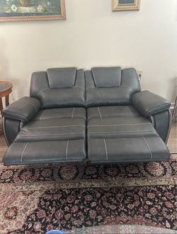 Costco Leather Power black recliner loveseat, only 3 months old, nearly new, moving must sell.