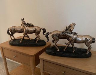 Two same galloping horse sculptures
