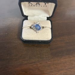 Ring with  Star Sapphire, And Surrounded By Smaller Crystals From Kay Jewelers