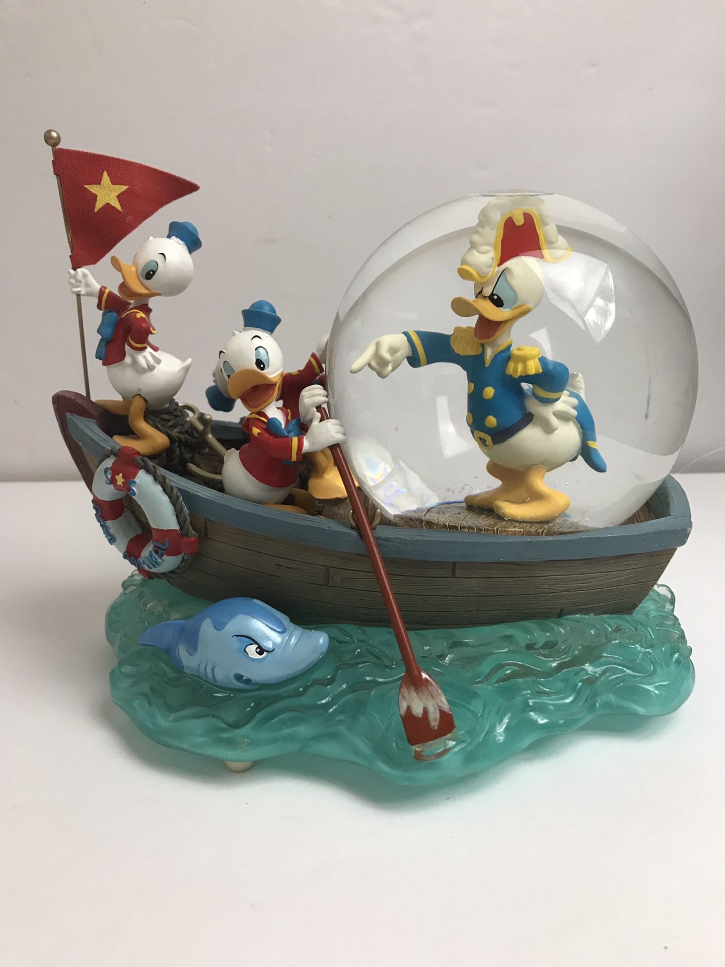 Disney snow globe Donald Duck and sea scouts in boat shark musical