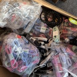 bulk lot of various phone chargers, wires, and connectors.  