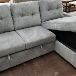 Gray fabric sofa chaise sectional with a pullout bed