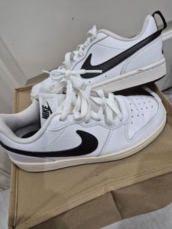 Youth black with white Nike shoes