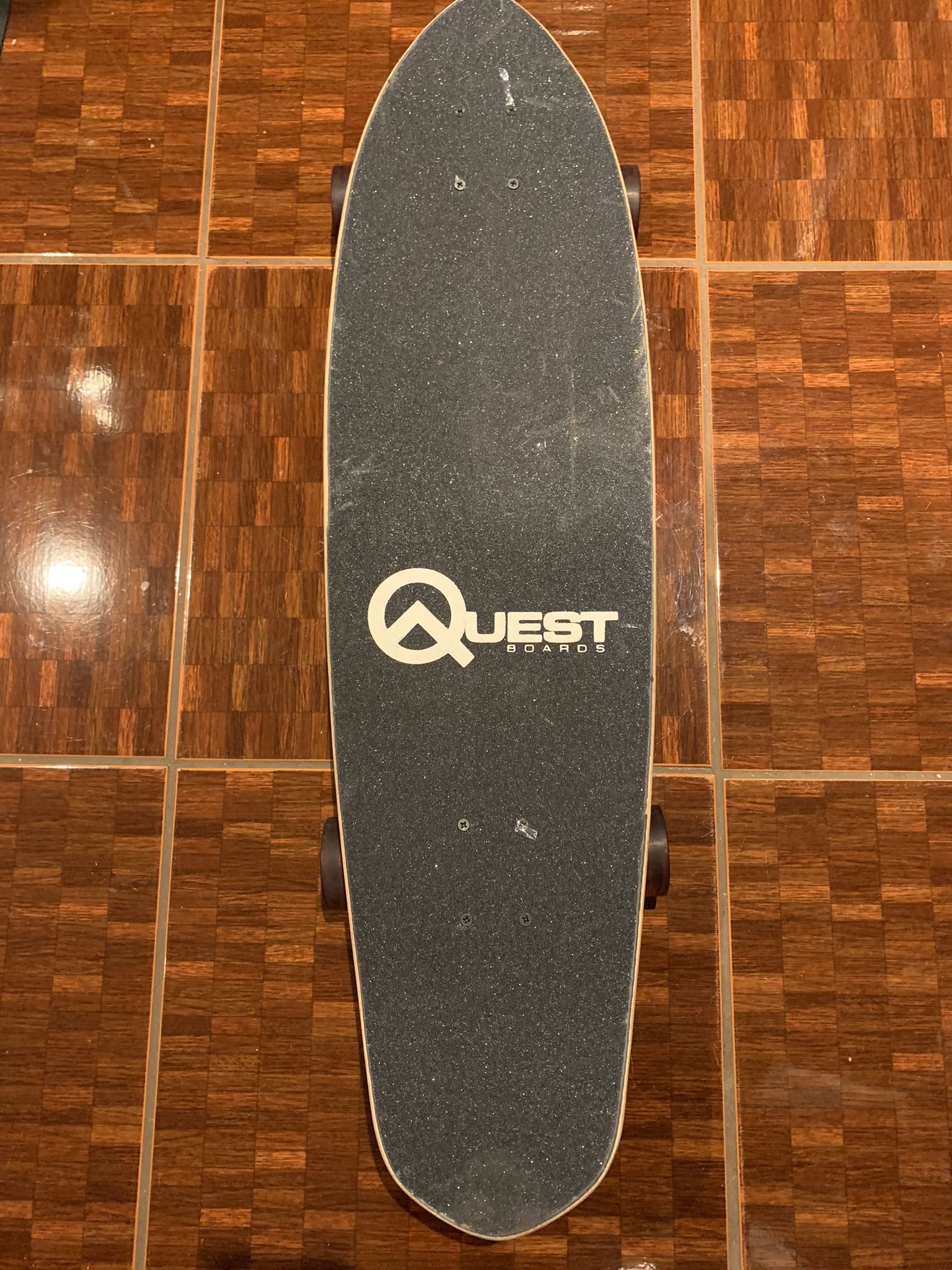 Quest 36” cruiser board skeleton hand holding surfboard design