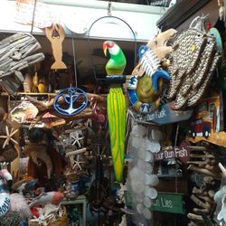 Large Carved Colorful Wooden Parrot On A Swing