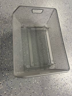 Sliding storage basket for a cabinet