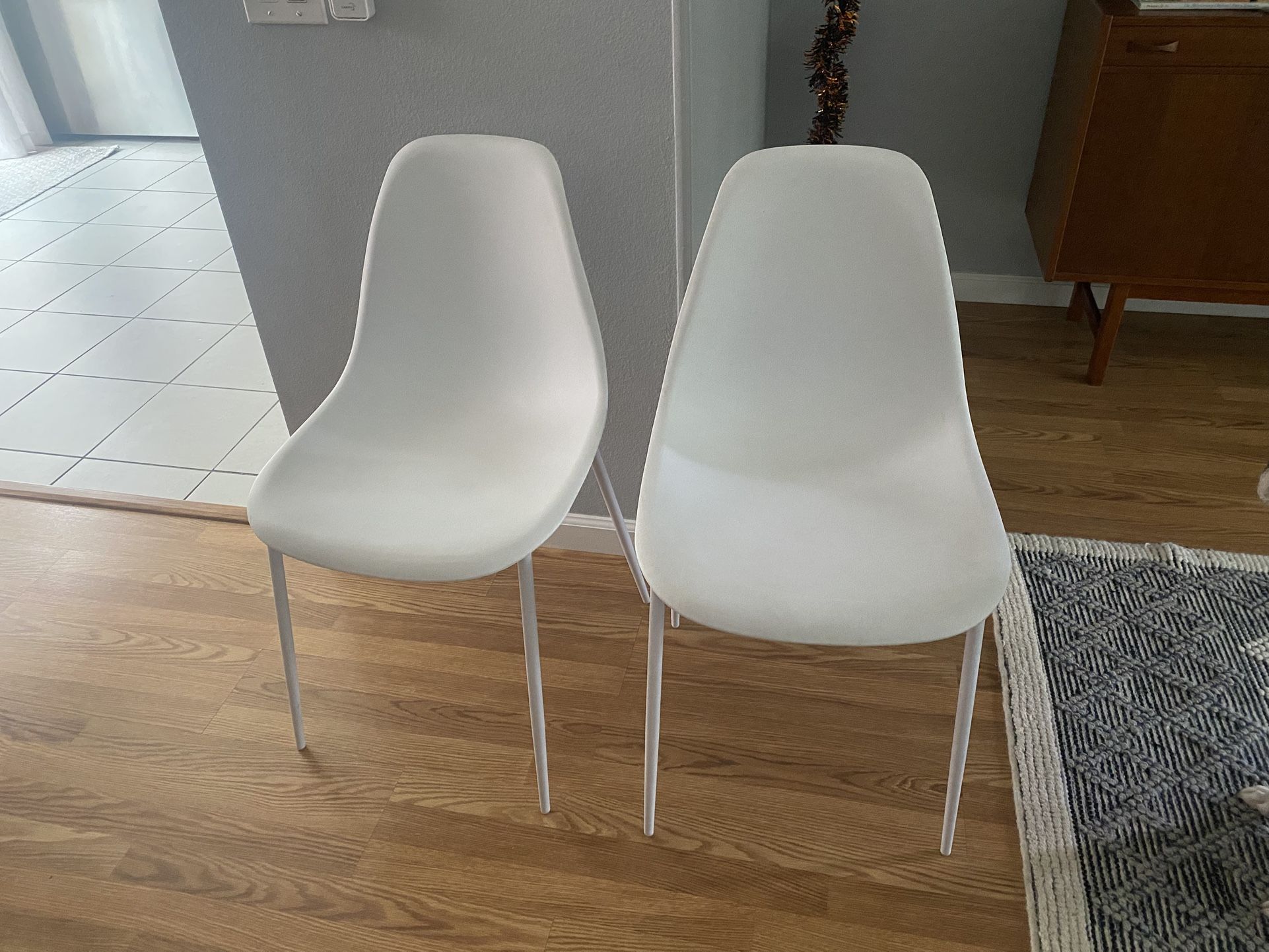 Two matching white Chairs