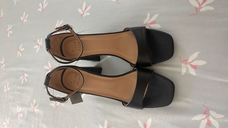Brand new black high-heeled sandals.