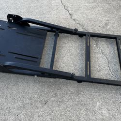 This is a racing simulator cockpit with a Logitech G29 Driving Force racing wheel and pedals