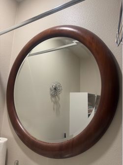 Dark brown round wall mirror