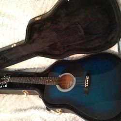 Johnson acoustic guitar and hard leather guitar case