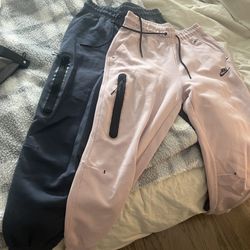 2 pairs of nike tech joggers