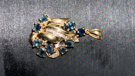 14K  pendant set with multiple oval blue sapphires and small diamonds
