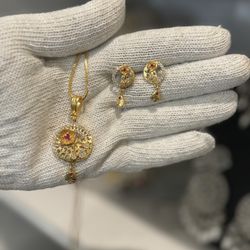 gold plated locket set with studs and ad stone 