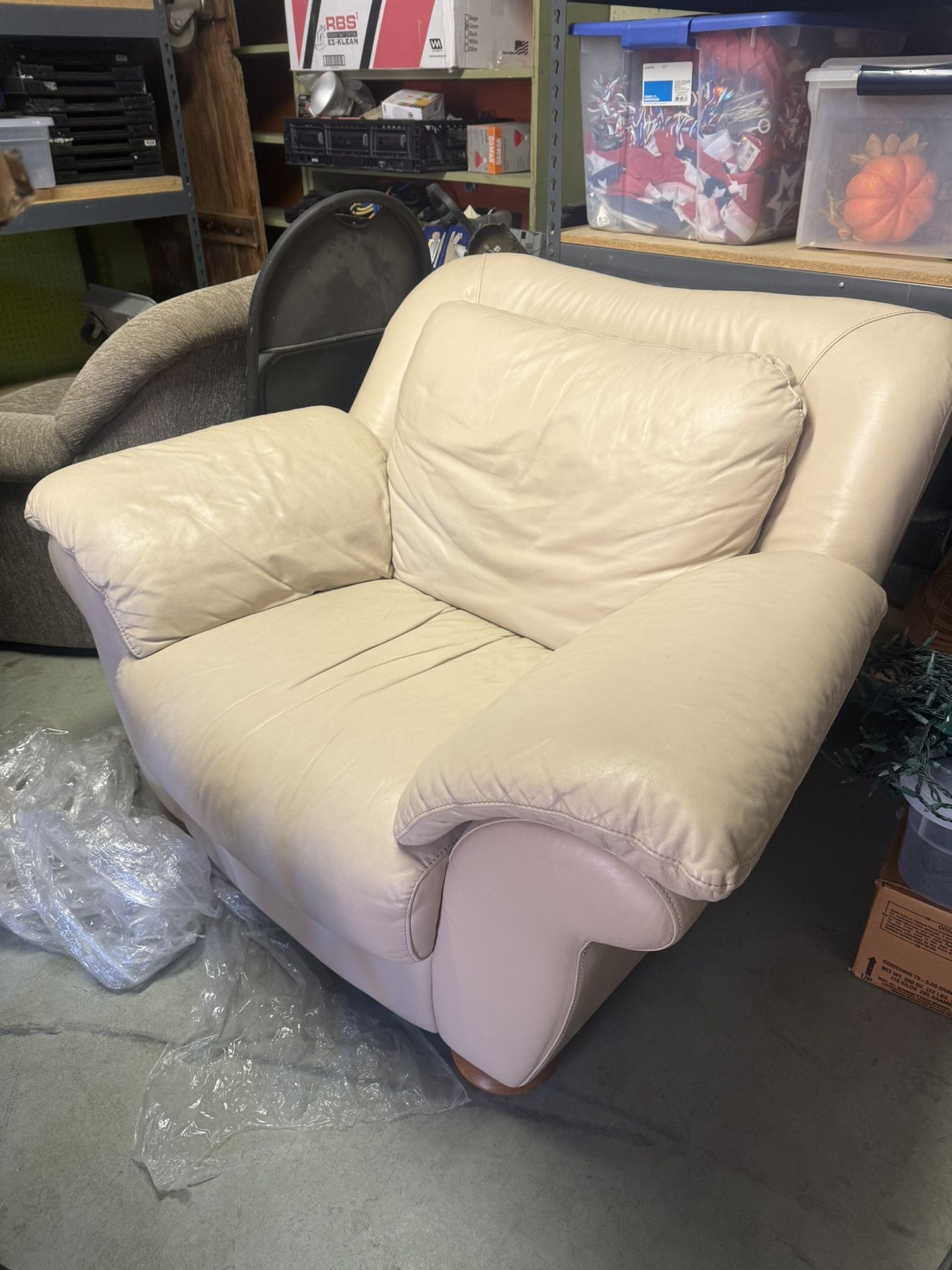 Two leather arm chairs and matching Ottomans
