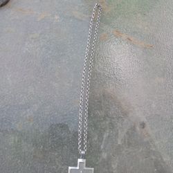 A Sterling Silver Chain With A Cross With A Little Diamond On It