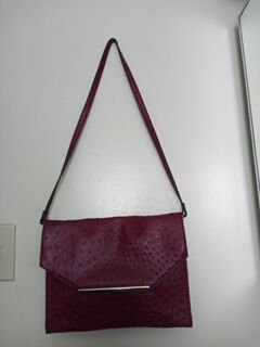 A slim red crossbody purse