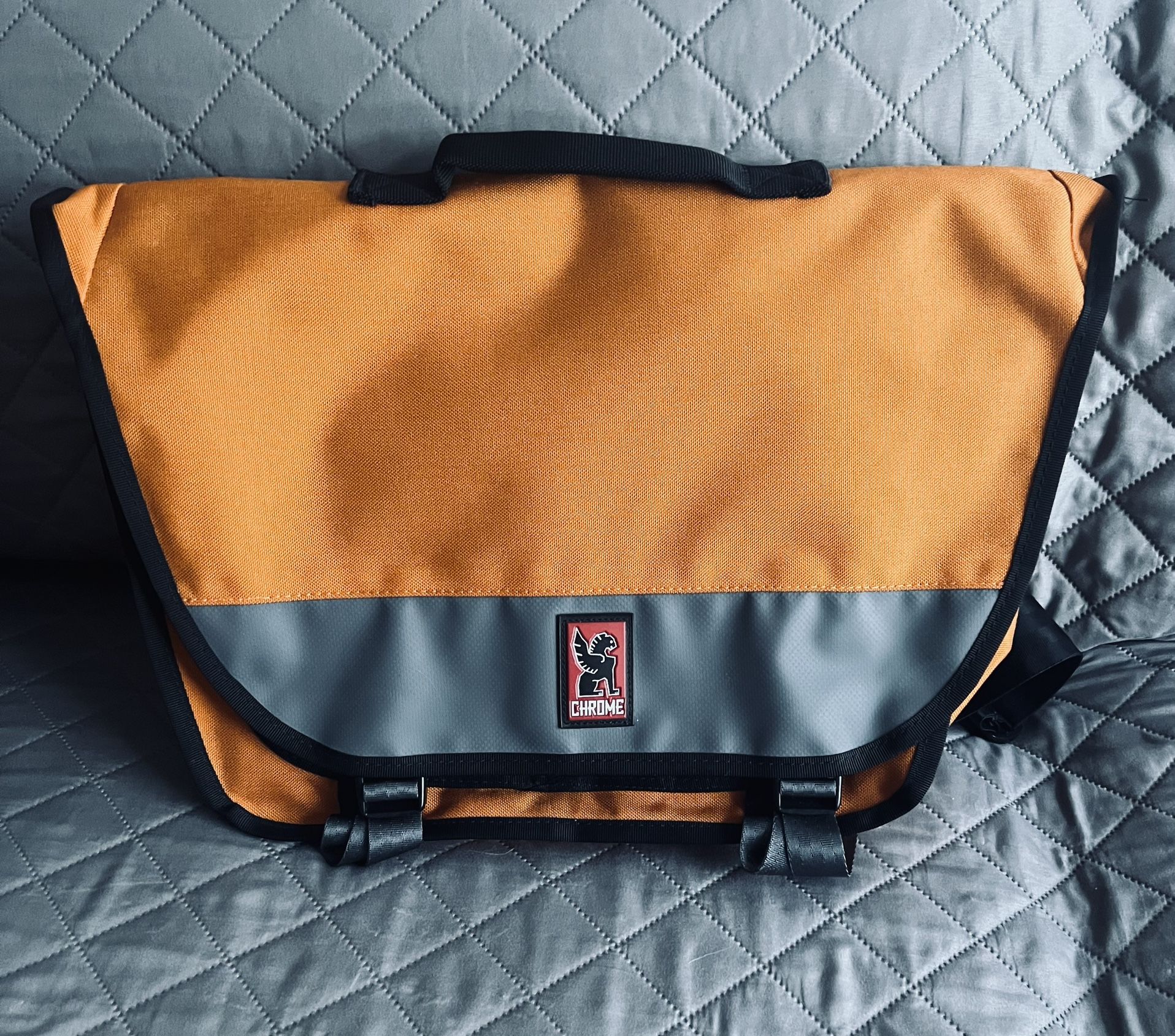 Chrome citizen messenger cross body bag with seat belt buckle in orange
