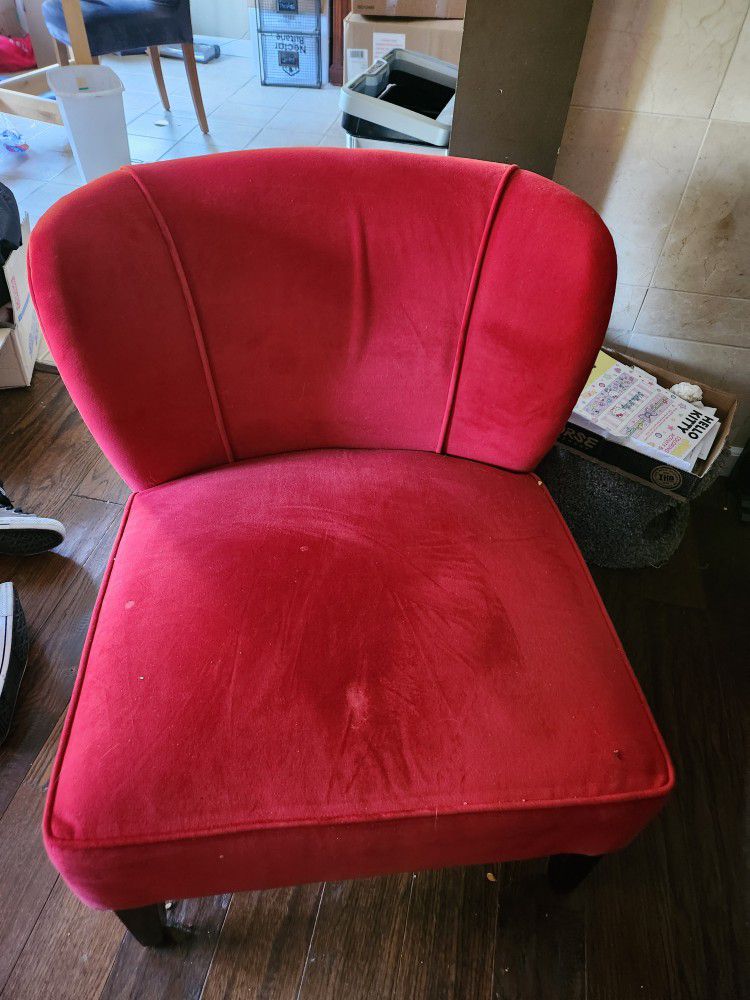 A visually appealing Accent chair upholstered in luxurious red velour fabric.