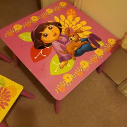 Girls table and chair sit  Is Dora the Explorer