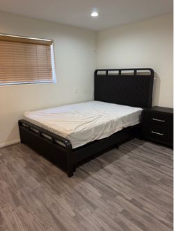 Black queen bed with dresser and mirror and mattress