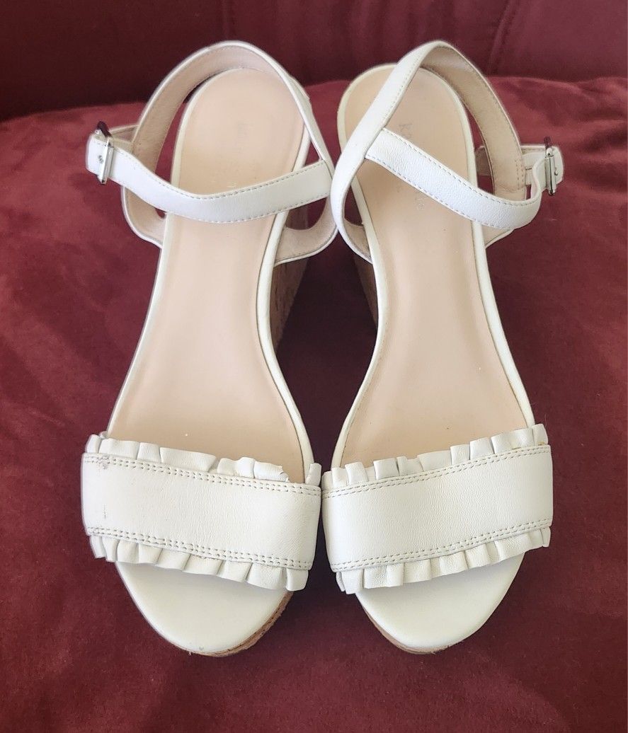 Kate Spade New York Tomas white leather ruffle wedge cork platform sandals.