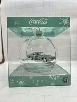 This is a 2025 M2 Machines Christmas Ornament featuring a Coca-Cola 1969 Chevrolet Camaro diecast model