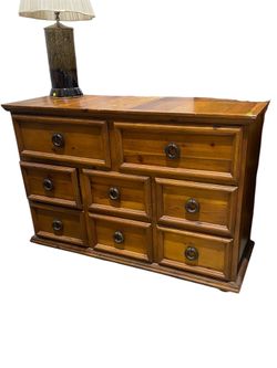 Vintage solid pine wood dresser features a medium-to-dark stain and distinctive rugged ring handles