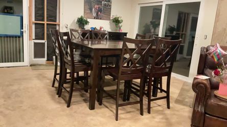 Tall dining room table with eight chairs
