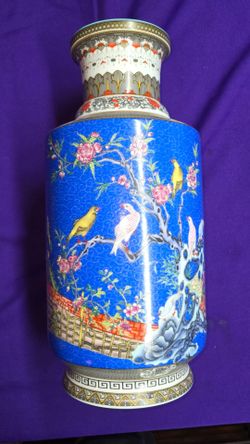 Chinese porcelain vase in the Famille Rose style, featuring vibrant blue enamel and bird-and-flower motifs. Period and Mark: The stamp appears to be a