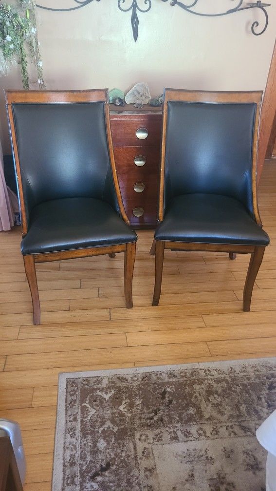 Pair Of Wooden Chairs with Black Vegan Leather Cushioning