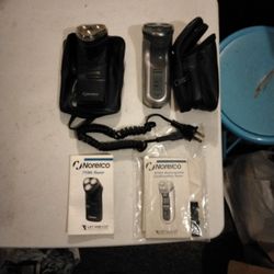 2 Norelco Razors With Instructions,  Covers, Cases, And 1 Charger