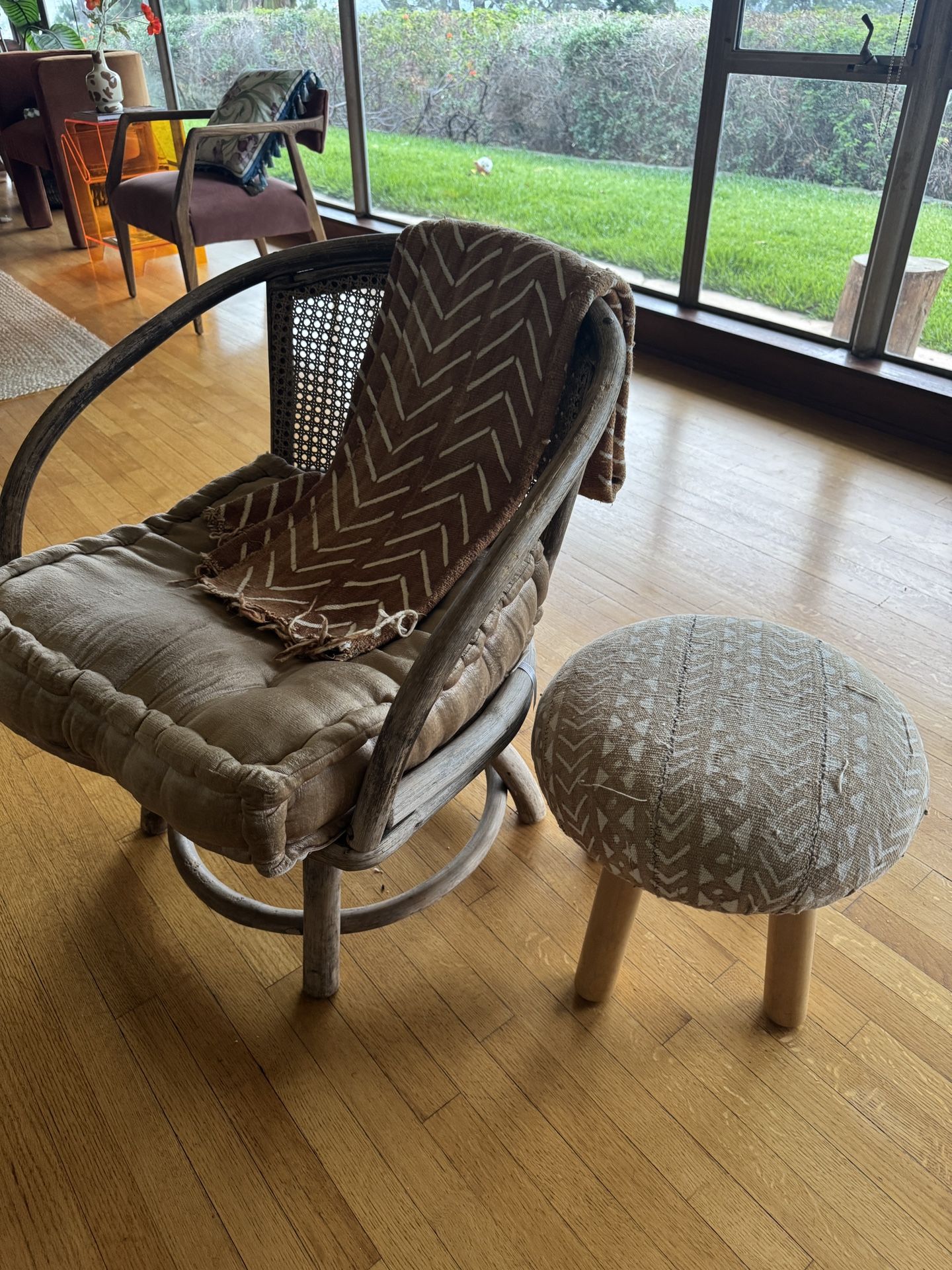 Vintage Perigold Rattan And Cane Accent Chair with cushion, African print rug And Accent stool