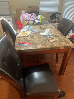 Marble dining table with leather chairs