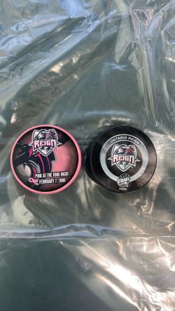 These two Ontario Reign souvenir hockey pucks from their ECHL era (2008–2015)