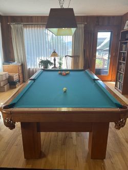 Pool table with overhead light and cues