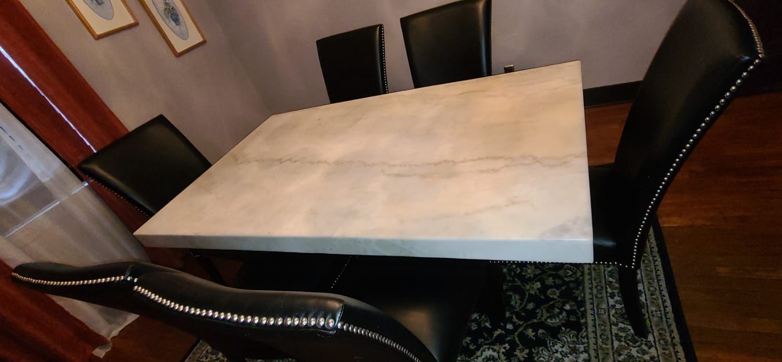 Marble dining table and 6 black lather chairs