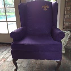 Purple sitting chair going for LSU look. Coffee table.