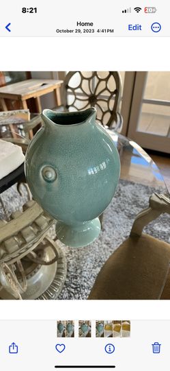 A great title could be:  "Unique Turquoise Fish-Shaped Pottery Vase - Decorative & Functional"