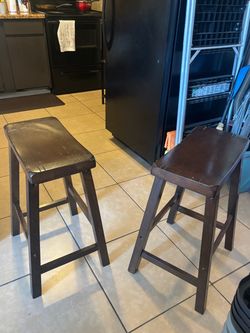 2 Brown wooden stools