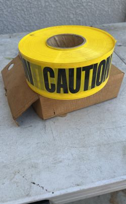 ROLL OF NEW CAUTION TAPE IN BOX