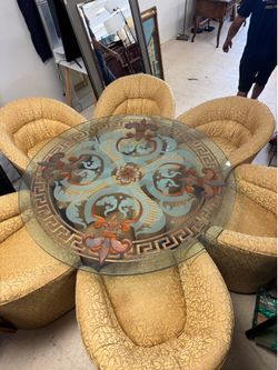 Custom dining set features ornate gold armchairs upholstered in a yellow patterned fabric and a round glass-top table & table base w/ additional 4 sma