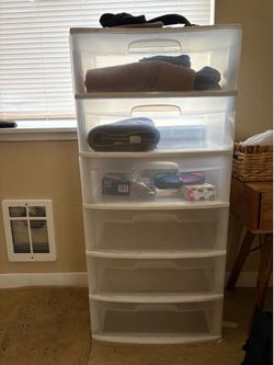 Two stackable six drawer clear storage containers