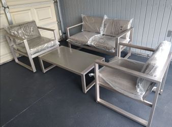 Outdoor patio loveseat with chairs and coffee table