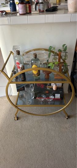Gold and glass circular bar cart