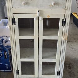 Wooden storage cabinet with glass pane doors